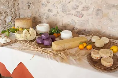 a long table with plates of food on it at Fattoria Manostalla Villa Chiarelli in Balestrate