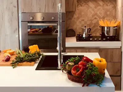 a kitchen counter with a basket of vegetables on it at flAle's holiday house in Cefalù