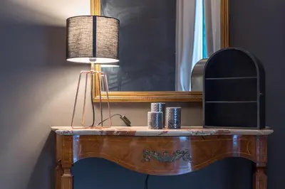 a dressing table with a lamp and a mirror at Qasr Home Beautiful apartment in Palermo in Palermo