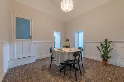 a dining room with a table and some chairs at Qasr Home Beautiful apartment in Palermo in Palermo