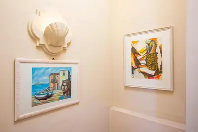 a room with two pictures on the wall at Solemar Sicilia - Casa Porto Bagnera in Santa Flavia