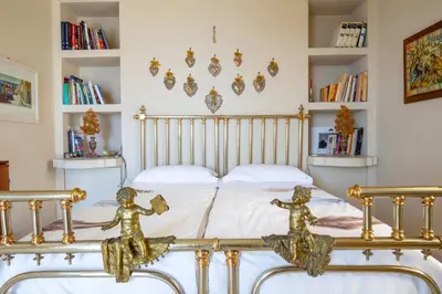 a bedroom with a bed with gold statues on it at Solemar Sicilia - Casa Porto Bagnera in Santa Flavia