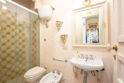 a bathroom with a toilet and a sink at Solemar Sicilia - Casa Porto Bagnera in Santa Flavia