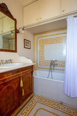 a bathroom with a tub and a sink and a mirror at Solemar Sicilia - Casa Porto Bagnera in Santa Flavia