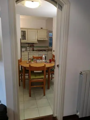 a kitchen with a table and chairs in a room at A casa di Zara in Termini Imerese
