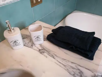 a bathroom with a sink and a towel and a toilet at A casa di Zara in Termini Imerese
