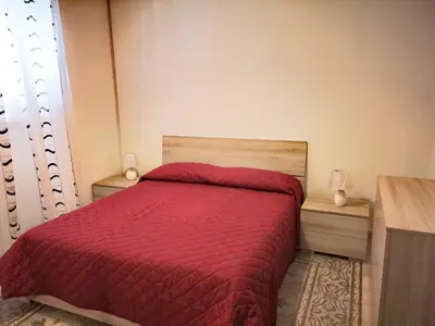 a bedroom with a bed with a blue bedspread at I babbaluci in Palermo