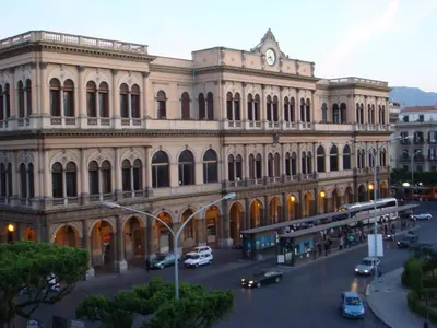a large building with a clock on top of it at I babbaluci in Palermo