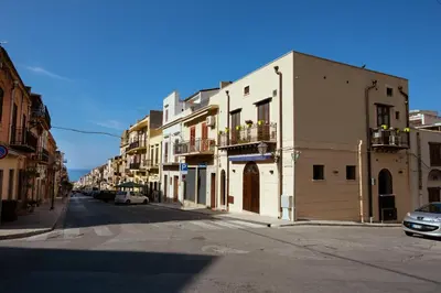 an empty street with buildings on the side of the road at Camere Simona in Castellammare del Golfo