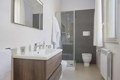 a bathroom with a sink and a toilet and a shower at Villa Biancolilla in Castellammare del Golfo