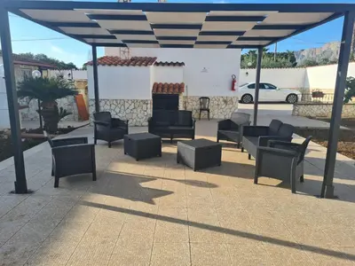 a group of chairs and tables under a pavilion at RESORT Valle del Re in Partinico