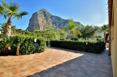 a driveway with a mountain in the background at Villa Minoa con piscina in San Vito lo Capo