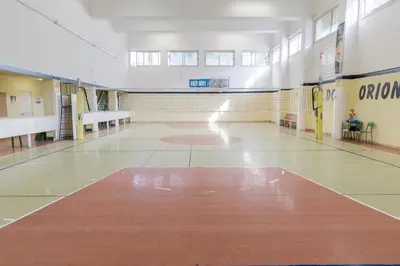 an empty gymnasium with a basketball court in a building at Casa per Ferie Don Orione Palermo in Palermo