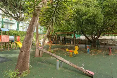 a playground with a fallen tree trunk in a park at Casa per Ferie Don Orione Palermo in Palermo