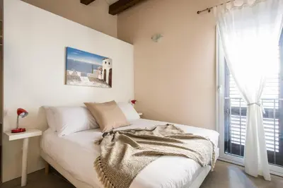 a white bed in a room with a window at Santa Cecilia Apartment by Wonderful Italy in Palermo
