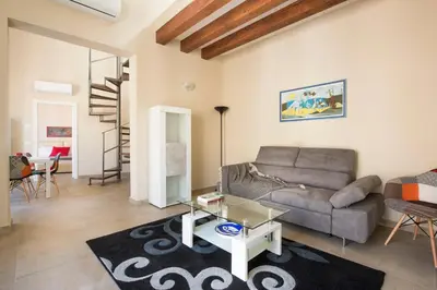 a living room with a couch and a table at Santa Cecilia Apartment by Wonderful Italy in Palermo