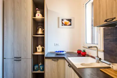 a kitchen with a sink and a refrigerator at Santa Cecilia Apartment by Wonderful Italy in Palermo
