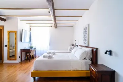 a bedroom with a white bed and a desk at Villa Vittoria Hotel in Alcamo