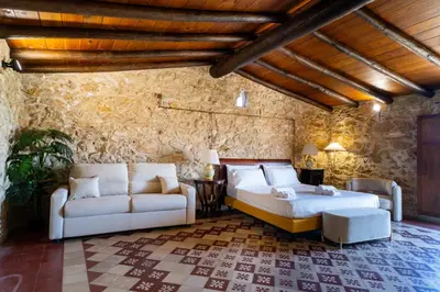 a living room with two beds and a couch at Villa Vittoria Hotel in Alcamo