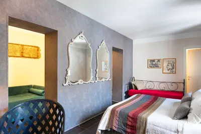 a bedroom with a bed and a mirror on the wall at Il Giardino di Ballarò Boutique B&B in Palermo