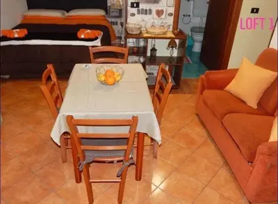 a table with a bowl of fruit on it in a living room at Loft CASA PROFESSA 1 in Palermo