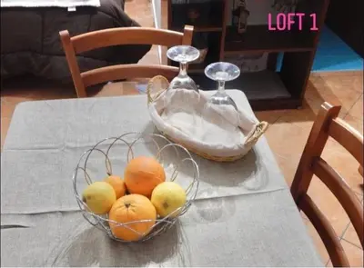a bowl of oranges and lemons on a table at Loft CASA PROFESSA 1 in Palermo