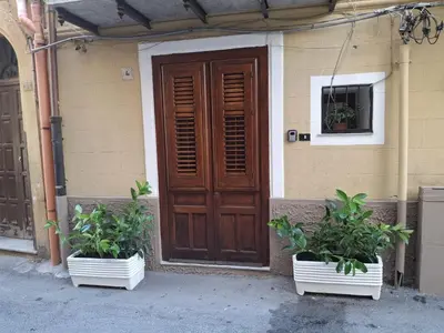 two potted plants sitting in front of a door at Loft CASA PROFESSA 1 in Palermo