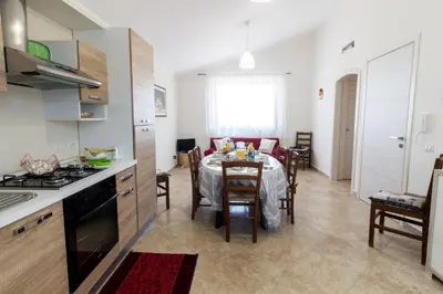 a kitchen and dining room with a table and chairs at A casa di Simona in Monreale
