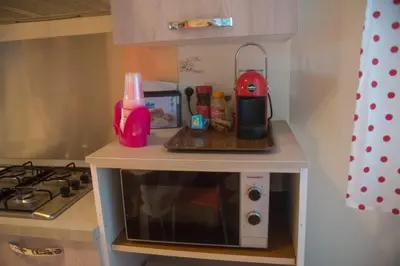 a small kitchen with a microwave on a counter at La Casita 24 in Palermo