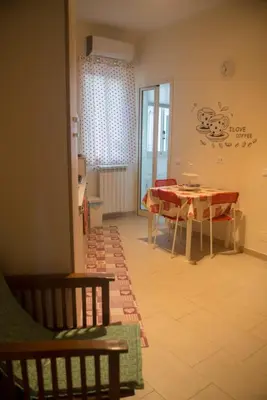 a dining room with a table and chairs in a room at La Casita 24 in Palermo