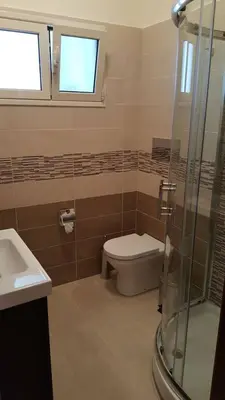 a bathroom with a toilet and a glass shower at La Casita 24 in Palermo