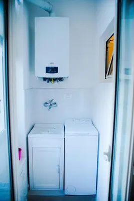 a bathroom with a sink and a washer and dryer at La Casita 24 in Palermo
