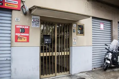 a motorcycle parked in front of a garage at La Casita 24 in Palermo
