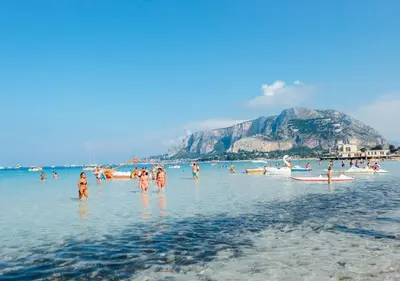 a group of people in the water at the beach at ALBA DEL CAPO in Palermo