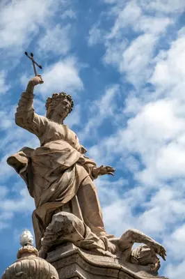 a statue of a woman holding a cross at ALBA DEL CAPO in Palermo