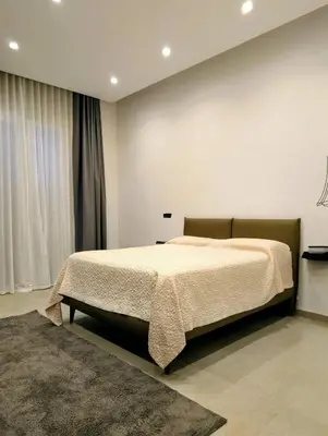 a bedroom with a bed and a large window at Porta di Castro Hotel & SPA in Palermo