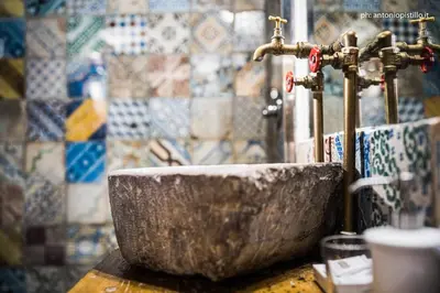 a stone sink in a bathroom with a tap at Porta di Castro Hotel & SPA in Palermo