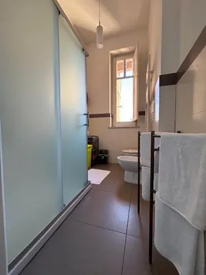 a bathroom with a glass shower and a toilet at Mamamia #Teatro Massimo in Palermo