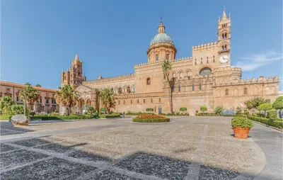 a large building with a clock tower on it at Villa Joly in Terrasini