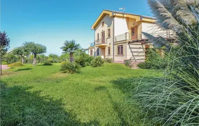 a house with a green yard in front of it at Villa Joly in Terrasini