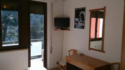 a bedroom with a bed and two windows and a television at MillePini in Calatafimi