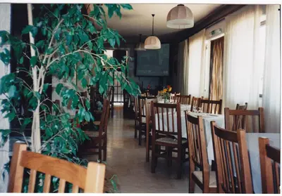 a group of people sitting at tables in a room at MillePini in Calatafimi