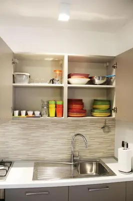 a kitchen with a sink and some plates and bowls at Mamiani Suite in Castellammare del Golfo