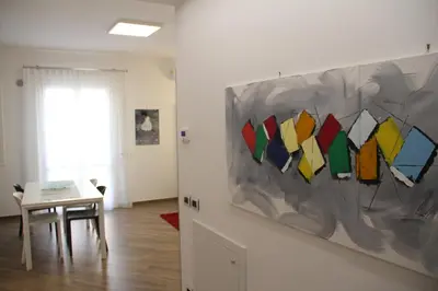 a room with a table and a painting on the wall at Mamiani Suite in Castellammare del Golfo