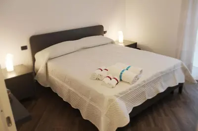 a bedroom with a bed with towels on it at Mamiani Suite in Castellammare del Golfo
