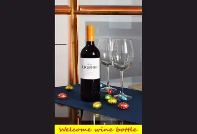a bottle of wine and two wine glasses on a table at Casa Santa Sofia in Palermo