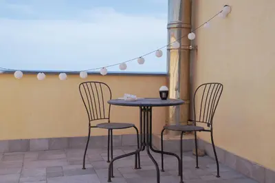 a table and chairs in front of a building at Seaside 3 Bedroom Villa with 2 Terrace and private parking - Villa Porta Azzurro in Termini Imerese