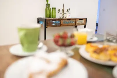 a table with plates of food and a cup of coffee at Ai Tre Mercati in Palermo