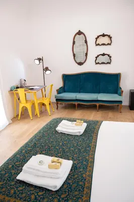 a living room with a blue couch and a table at Ai Tre Mercati in Palermo
