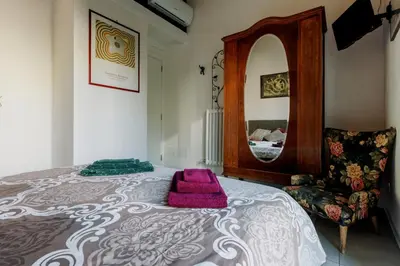 a bedroom with a large bed and a mirror at Arimatea Accommodations in Palermo
